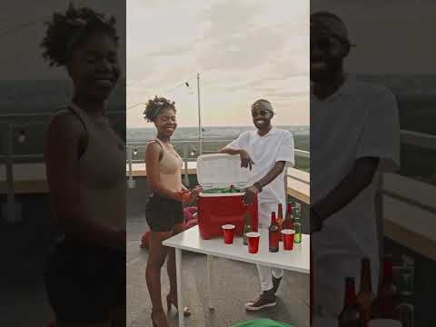 Happy Man and Woman Posing on Rooftop Terrace with Mini Fridge